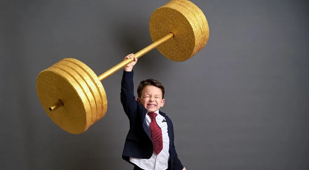 Niño con pesas en traje, impulsa tu crecimiento